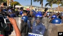 Riot police break up a press conference by opposition leader Nelson Chamisa in Harare, Zimbabwe, Aug. 3, 2018.