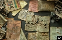 The belongings of some of those who were slaughtered as they sought refuge in the church are preserved in glass cases as a memorial to the thousands who were killed in the 1994 genocide in Rwanda.