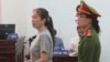 Prominent blogger Nguyen Ngoc Nhu Quynh, left, stands trial in the south central province of Khanh Hoa, Vietnam, June 29, 2017. She was accused of distorting government policies and defaming the Communist regime on her Facebook posts, her lawyer said.