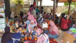 Anak-anak korban banjir di Batu, Jawa Timur, bermain di posko kesehatan dan psikososial yang didirikan oleh komunitas ALIT Indonesia dan Kalingga, pada 12 November 2021. (Foto: VOA/Petrus Riski)
