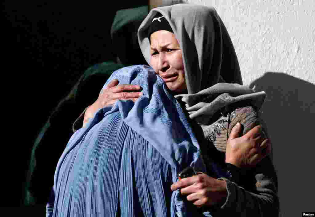 Afghan women mourn inside a hospital compound after a suicide attack in Kabul, Afghanistan.