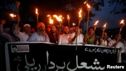 Protesters condemn the killing of Abdul Wali Khan University student Mashal Khan, after he was accused of blasphemy, during a protest in Peshawar, Pakistan, April 20, 2017. The banner reads, "We are all Mashal's Brothers." 