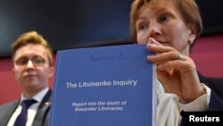 Marina Litvinenko widow of Alexander Litvinenko poses with a copy of The Litvinenko Inquiry Report with her son Anatoly (L) during a news conference in London, Britain, Jan. 21, 2016. 