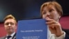 Marina Litvinenko, widow of ex-KGB agent Alexander Litvinenko, poses with a copy of "The Litvinenko Inquiry" with her son, Anatoly, during a news conference in London, Jan. 21, 2016. 