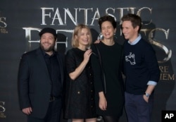 FILE - Actors Dan Fogler (from left) Alison Sudol, Katherine Waterston and Eddie Redmayne pose for photographers for the film 'Fantastic Beasts and Where to Find Them,' at a central London hotel, Oct. 13, 2016.