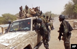 FILE - In this photo taken Feb. 19, 2015, Cameroon soldiers check a truck on the border between Cameroon and Nigeria as they combat regional Islamic extremists force's including Boko Haram.