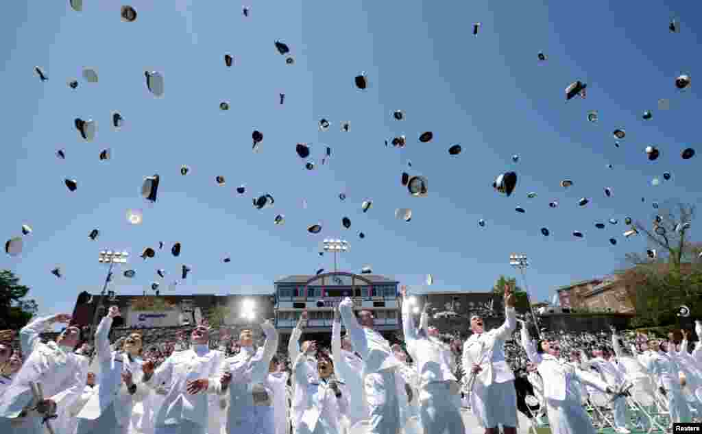 Ensigns toss their caps into the air upon the completion of the United States Coast Guard Academy Commencement Ceremony in New London, Connecticut.