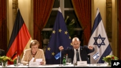 German Chancellor Angela Merkel and Israeli Prime Minister Naftali Bennett take part in a roundtable discussion with Israeli entrepreneurs, in Jerusalem, Oct. 10, 2021. 