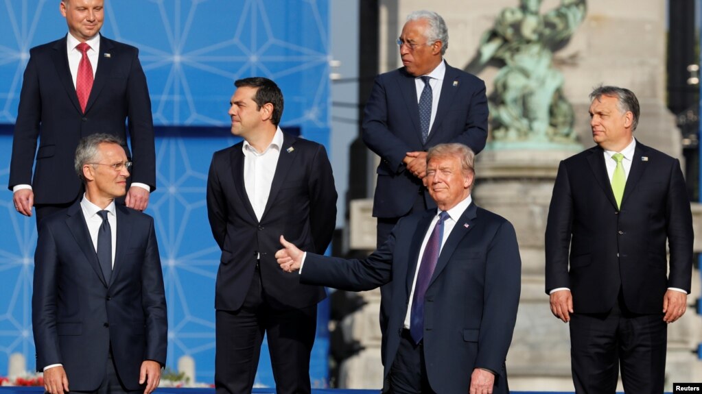 NATO Secretary General Jens Stoltenberg, Poland's President Andrzej Duda, Greek Prime Minister Alexis Tsipras, U.S. President Donald Trump, Portugal's Prime Minister Antonio Costa, Hungarian Prime Minister Viktor Orban pose for a group photo in the park o