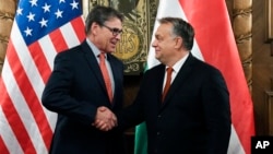 Hungarian Prime Minister Viktor Orban, right, shakes hands with U.S. Energy Secretary Rick Perry during their meeting in Orban's office in the Parliament building in Budapest, Hungary, Nov. 13, 2018.
