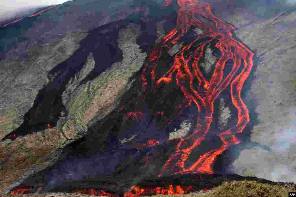 Lava flows out of the Piton de la Fournaise volcano as it erupts on the French island of La Reunion in the Indian Ocean.&nbsp;The Piton de la Fournaise started to erupt at 10 am local time in the Faujas crater northeast of Dolomieu.
