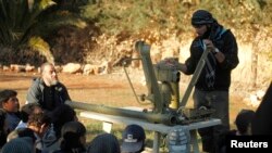 FILE - A Free Syrian Army trainer addresses fellow fighters as he conducts a demonstration on how to use anti-tank and anti-aircraft weapons at a training camp in the northern countryside of Aleppo, March 31, 2014.