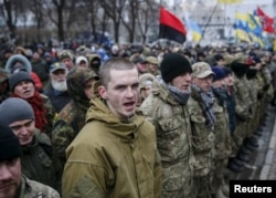 Members of self-defense battalions take part in a rally to commemorate demonstrators who were killed during the Maidan protests in 2014 in Kiev, Ukraine, Feb. 20, 2016.