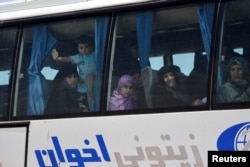 FILE - People are seen in the bus released by militants from Idlib, Syria May 1, 2018. (SANA/Handout via Reuters)