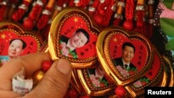 중국 공산당 제19기 중앙위원회 3차 전체회의가 26일 베이징에서 개막했다. 베이징 기념품 가게에서 시진핑 국가주석의 모습을 담은 목걸이를 팔고 있다.
