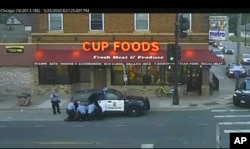 FILE - Minneapolis police officers from left, Tou Thao, Derek Chauvin, J. Alexander Kueng and Thomas Lane are seen attempting to take George Floyd into custody in Minneapolis, Minn., in this May 25, 2020 file image from surveillance video.