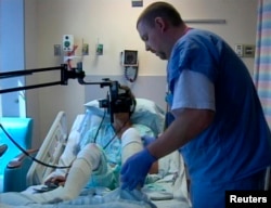 FILE - A hospital patient uses virtual reality treatment for pain in this undated photo.