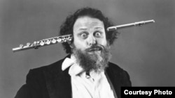 A 1980 photo of Professor Peter Schickele with a flute through his head. (Courtesy photo)
