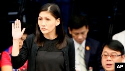 Maia S. Deguito, Rizal Commercial Banking Corporation (RCBC) branch manager, takes her oath prior to the start of the Philippine Senate Blue Ribbon Committee probe, March 16, 2016.