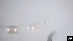 Vehicles commute southbound on the Garden State Parkway in whiteout conditions during a snowstorm in Eatontown, N.J., Jan. 4, 2018.