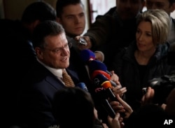 FILE - Presidential candidate and European Commission Vice President Maros Sefcovic speaks to media after casting his vote during the first round of presidential elections, in Bratislava, Slovakia, March 16, 2019.