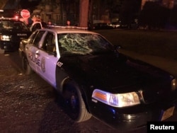 A police car with broken windows is seen in this photograph released by the Milwaukee Police Department after disturbances following the police shooting of a man in Milwaukee, Wisconsin, Aug. 13, 2016.