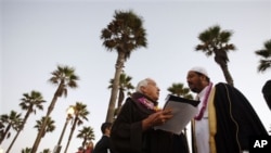 Rev. Christian Mondor, left, talks with Fawad Yacoob of the Islamic Society of Orange County at the Blessing of the Waves ceremony in Huntington Beach, California, a few years ago