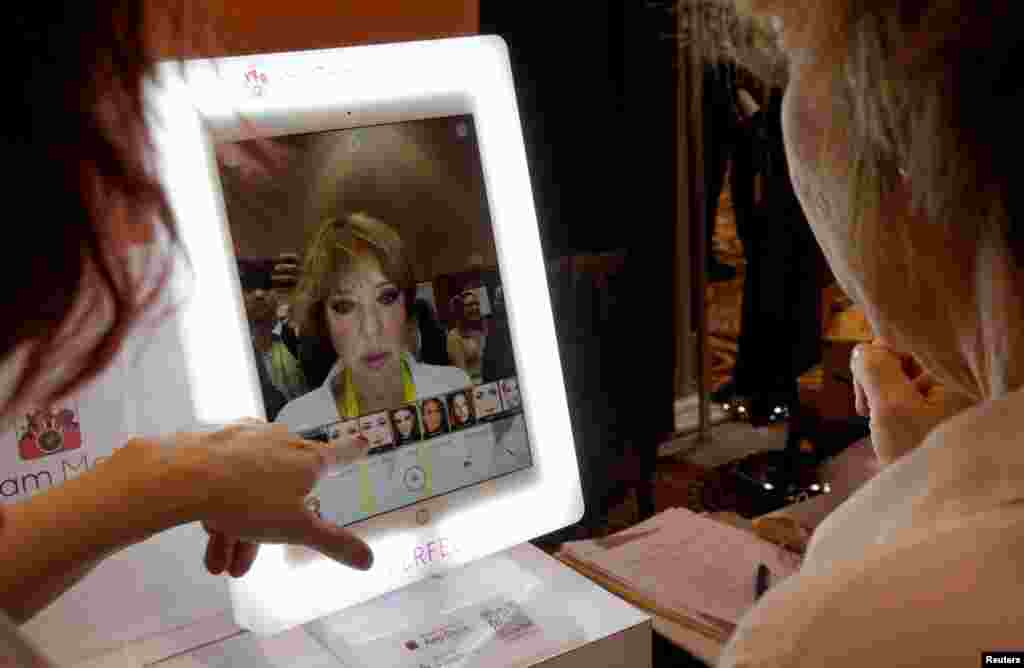 A show-goer tries out the YouCam Makeup mirror that shows different makeup without actually applying any, at the Consumer Electronics Show in Las Vegas, Nevada, Jan. 3, 2017.