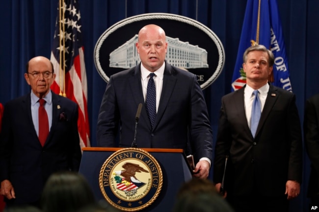 Acting Attorney General Matt Whitaker, center, with Commerce Secretary Wilbur Ross, left, and FBI Director Christopher Wray speak, Jan. 28, 2019, at the Justice Department in Washington during an announcement of an indictment on violations including bank and wire fraud of Chinese telecommunications companies including Huawei.