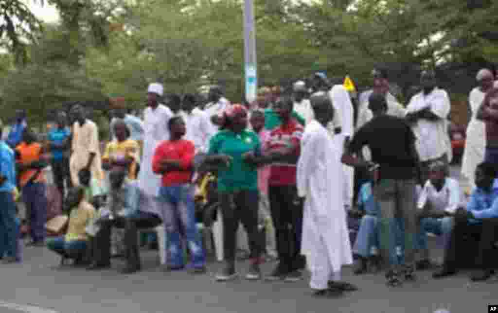 Voters waiting after casting ballots at their polling station in Abuja, , to hear the results