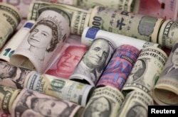 FILE - Euro, Hong Kong dollar, U.S. dollar, Japanese yen, British pound and Chinese 100-yuan banknotes are seen in a picture illustration shot, Jan. 21, 2016.
