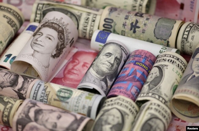 FILE - Euro, Hong Kong dollar, U.S. dollar, Japanese yen, British pound and Chinese 100-yuan banknotes are seen in a picture illustration shot, Jan. 21, 2016.