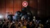 Journalists film a protester defaces the Hong Kong emblem inside the meeting hall of the Legislative Council in Hong Kong, Monday, July 1, 2019. 