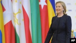 US Secretary of State Hillary Clinton against the backdrop of OSCE country flags at the organization's summit in Astana, Kazakhstan, 01 Dec 2010