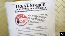 A sign explaining the local state of emergency because of a measles outbreak at the Rockland County Health Department in Pomona, N.Y., March 27, 2019.