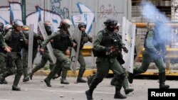 FILE - Security forces charge on anti-government protesters in Caracas, Venezuela, July 22, 2017.