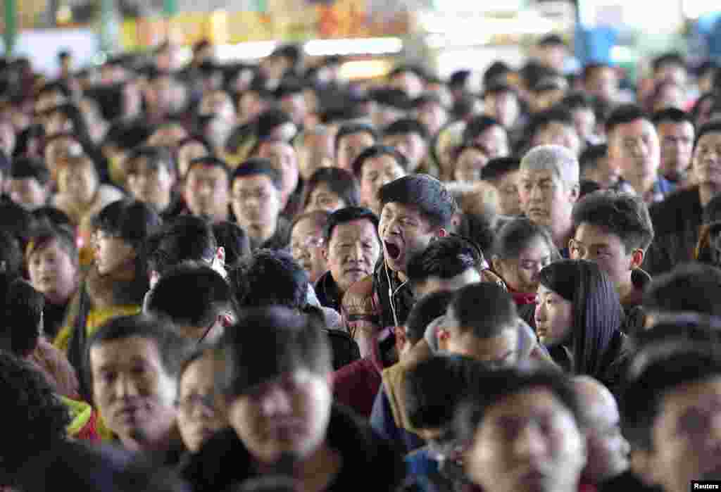 A man yawns at a railway station in Taiyuan, Shanxi province. The Chinese Ministry of Transport said a total of 2.807 billion trips are expected to be made during the 40-day Spring Festival travel rush, which started from Feb. 4 through Mar. 16, Xinhua News Agency reported.