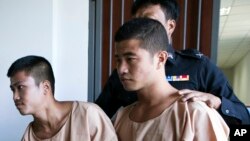 Myanmar migrants Win Zaw Htun, right, and Zaw Lin, left, are escorted by officials after their guilty verdict at court in Koh Samui, Thailand. The head of Myanmar's military has joined growing criticism on Dec. 27, 2015, of the death sentences Thailand to two men for a double murder on a resort island.