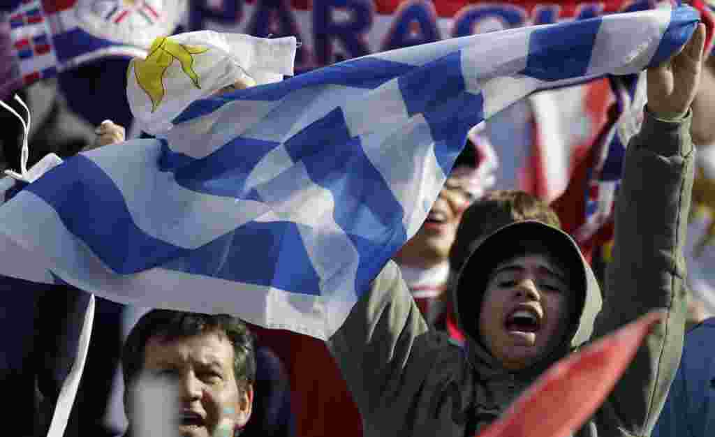 A fan waves an Uruguayan flag before the Copa America final soccer match between Uruguay and Paraguay in Buenos Aires, Argentina, Sunday, July 24, 2011. Uruguay is trying to become the tournament's most successful team, while Paraguay is looking to prove 