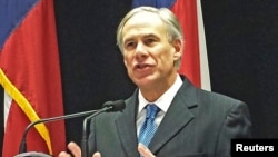 FILE - Texas Governor Greg Abbott is among more than two dozen governors, mostly Republicans, who have vowed to keep Syrian refugees from resettling in their states. 
