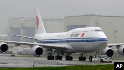 FILE -- The first Boeing 747-8 intercontinental airplane to be delivered to Air China is moved into position from Boeing's assembly facility to Paine Field in Everett, Wash., Sept. 29, 2014.
