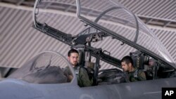FILE - In this file photo released Sept. 24, 2014 by the official Saudi Press Agency, Saudi pilots sits in the cockpit of a fighter jet as part of U.S.-led coalition airstrikes on Islamic State militants and other targets in Syria.