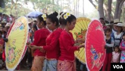 Dancers holding umbrellas in Siem Reap during the Khmer New Year celebration. 