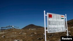 FILE - A signboard is seen from the Indian side of the Indo-China border at Bumla, in the northeastern Indian state of Arunachal Pradesh.