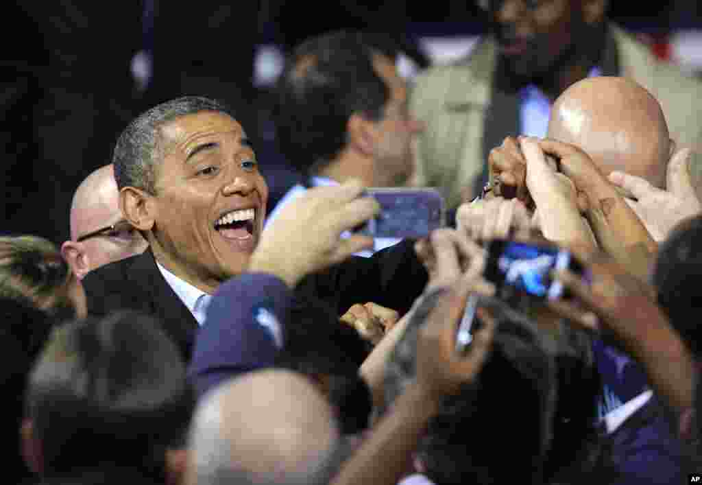 President Barack Obama smiles for cameras as he shakes hands with supporters after speaking at a campaign event at Nationwide Arena in Columbus, Ohio, Nov. 5, 2012.