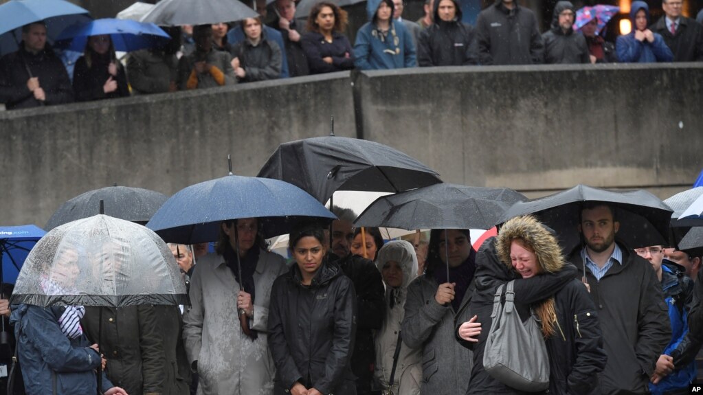 People near the scene of the recent attack observe a minute's silence in tribute to the victims of the attack at London Bridge and Borough Market, in central London, June 6, 2017.