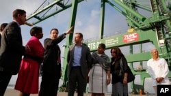 New York Governor Andrew Cuomo speaks with his delegation and Cuban officials as they visit a port's container terminal in the Bay of Mariel, Cuba, April 21, 2015.