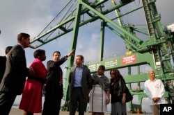 FILE - New York Governor Andrew Cuomo speaks with his delegation and Cuban officials as they visit a port's container terminal in the Bay of Mariel, Cuba, April 21, 2015.