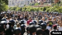 FILE - Interior Ministry members stand guard as activists take part in the LGBT Equality March in Kyiv, Ukraine, June 6, 2015.