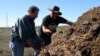 Jeffrey Creque (L) examines MCP Demonstration Ranch partner Loren Poncia’s (R) compost at the Stemple Creek Ranch prior to application. 